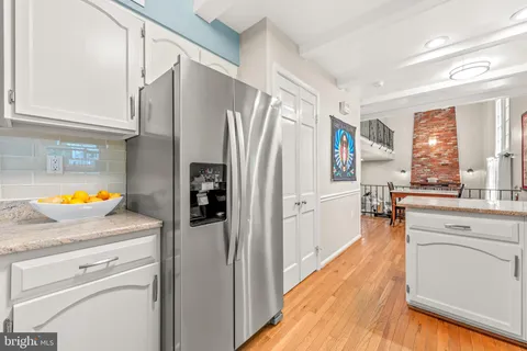 a kitchen with sink cabinets and dining table