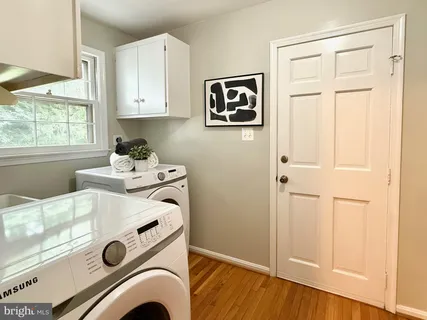 a living room with fireplace furniture and a rug