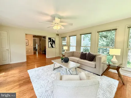 a living room with furniture and large windows