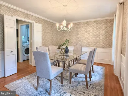 a view of a dining room with furniture and chandelier