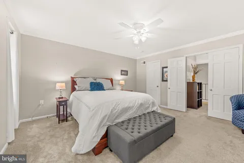 a spacious bedroom with a bed and a chandelier