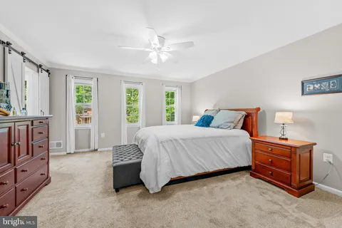 a bedroom with a bed and a bookshelf with wooden floor