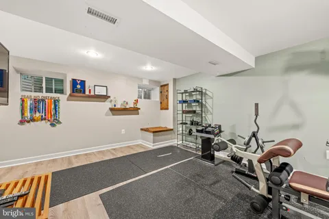 a aerial view of a house with table and chairs under an umbrella