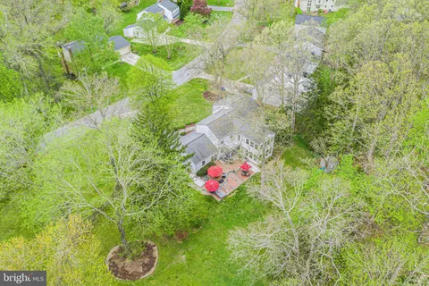 a patio with a table and chairs under an umbrella