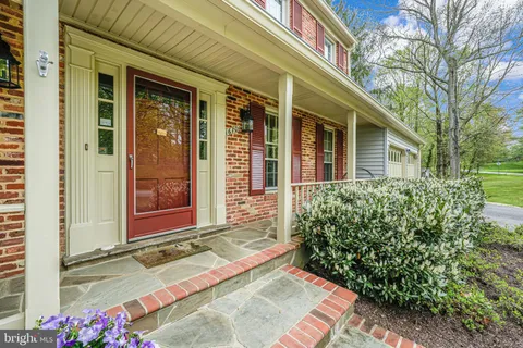 a view of entryway livingroom and hall with wooden floor