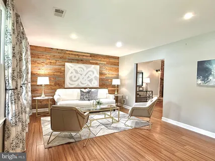 a living room with furniture and wooden floor