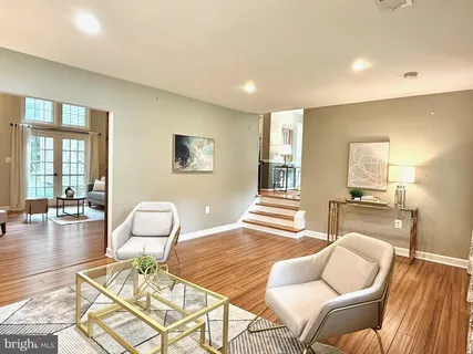 a living room with fireplace furniture wooden floor and a fireplace