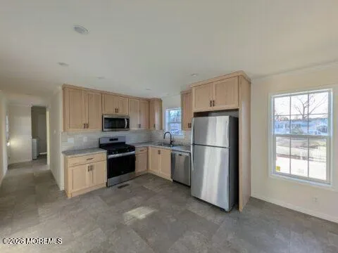 a kitchen with a refrigerator stove top oven and sink