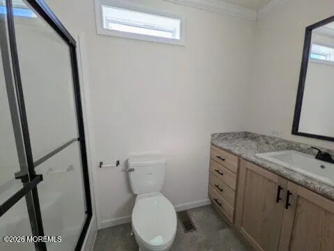 a bathroom with a granite countertop toilet sink and a mirror