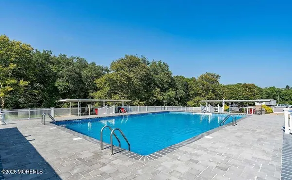 a view of a swimming pool with lounge chair