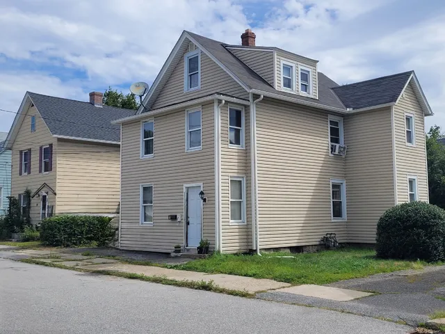 a view of a house with a small yard and plants
