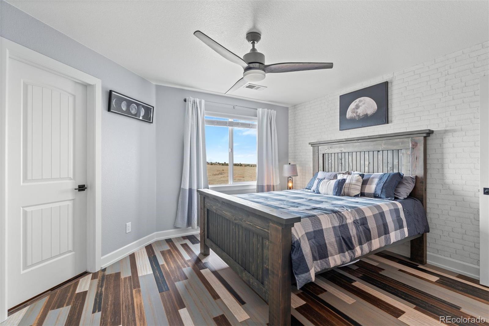 32335 Legacy Ridge Street Elizabeth, CO 80107 - Photo 17 of 50 a bedroom with a bed and a window