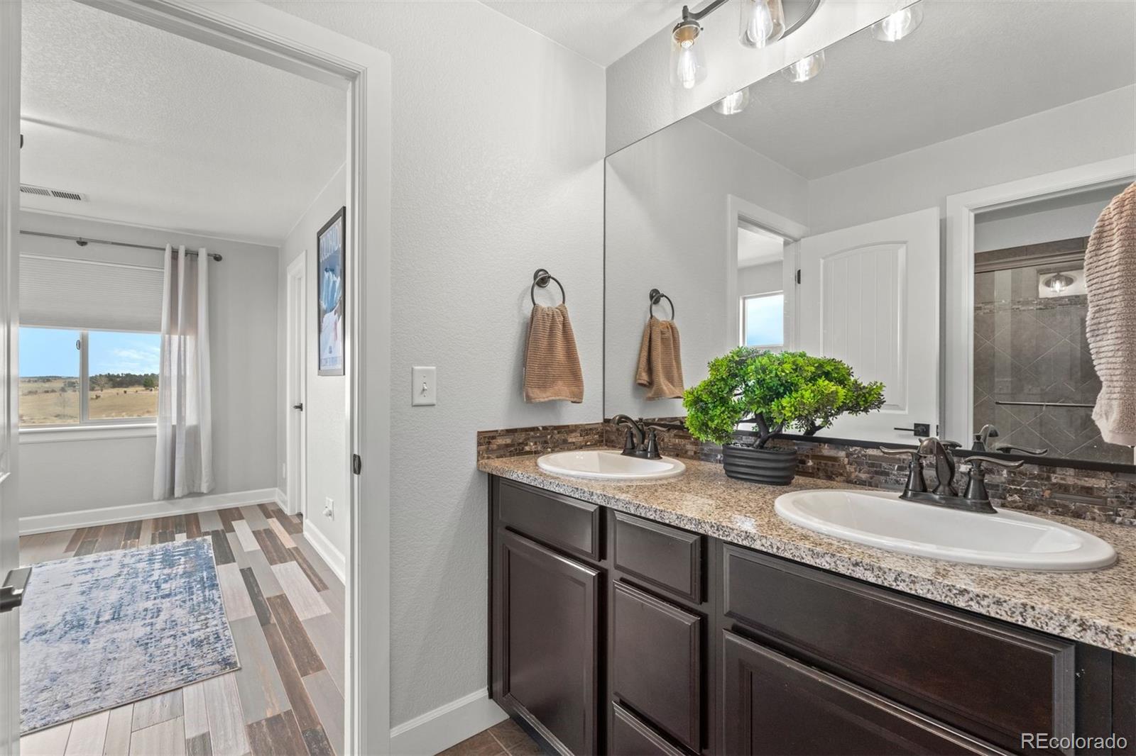 32335 Legacy Ridge Street Elizabeth, CO 80107 - Photo 18 of 50 a bathroom with sink and mirror