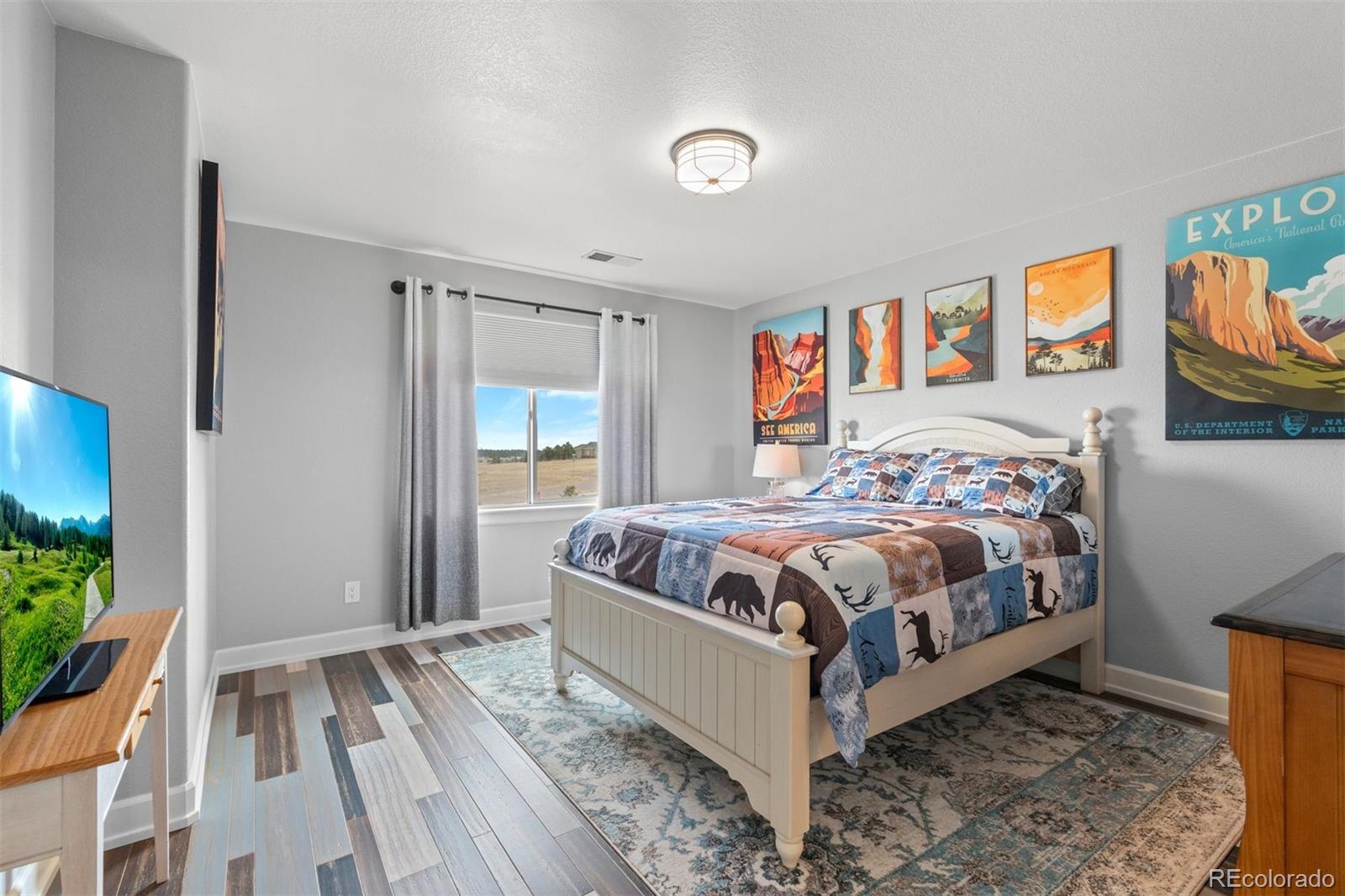 32335 Legacy Ridge Street Elizabeth, CO 80107 - Photo 20 of 50 a bedroom with a bed and a window