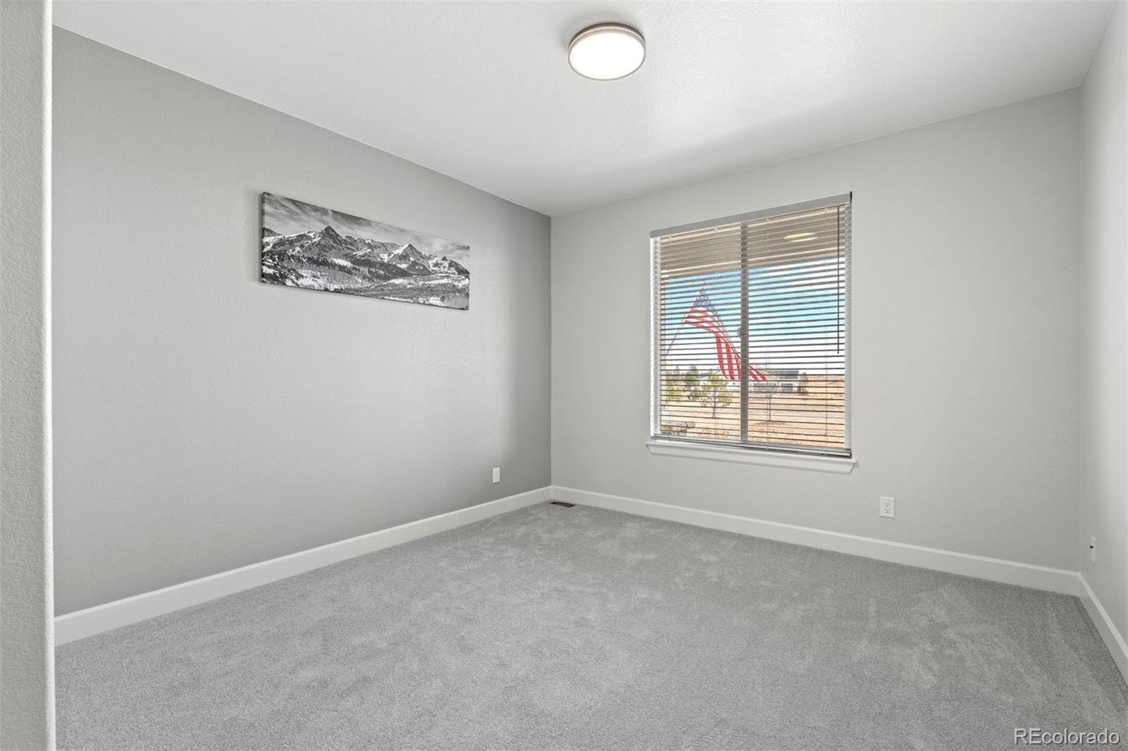 32335 Legacy Ridge Street Elizabeth, CO 80107 - Photo 26 of 50 an empty room with windows