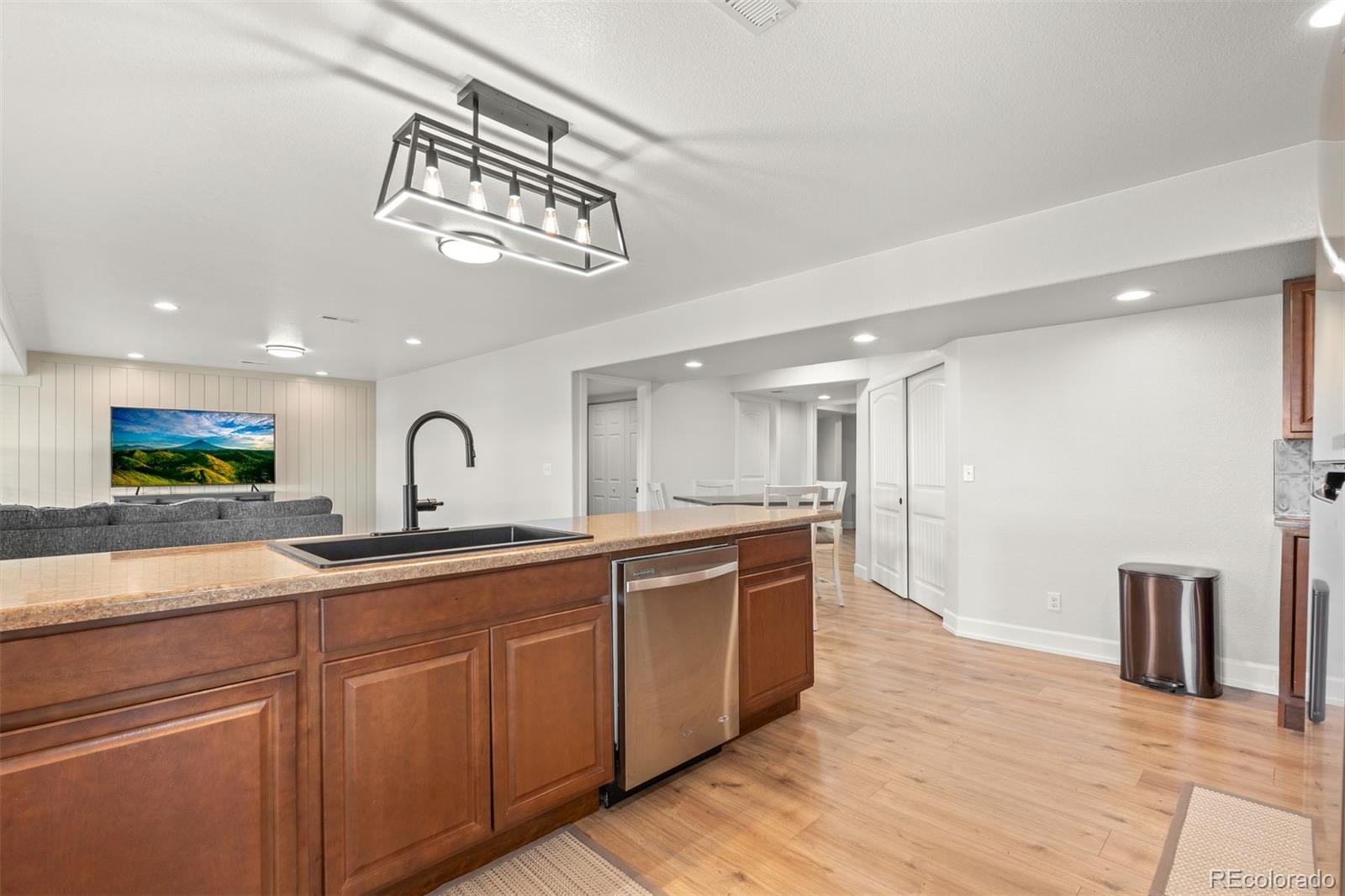 32335 Legacy Ridge Street Elizabeth, CO 80107 - Photo 31 of 50 a view of a kitchen with a sink and wooden floor