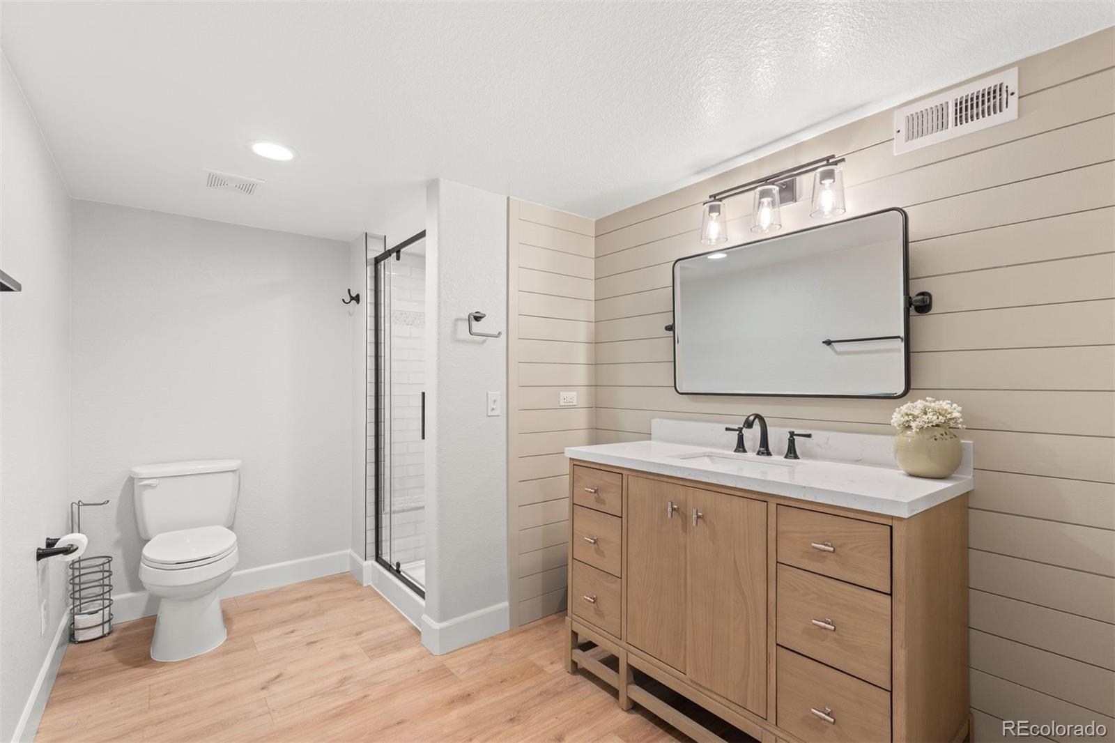 32335 Legacy Ridge Street Elizabeth, CO 80107 - Photo 36 of 50 a bathroom with a toilet sink double vanity and mirror