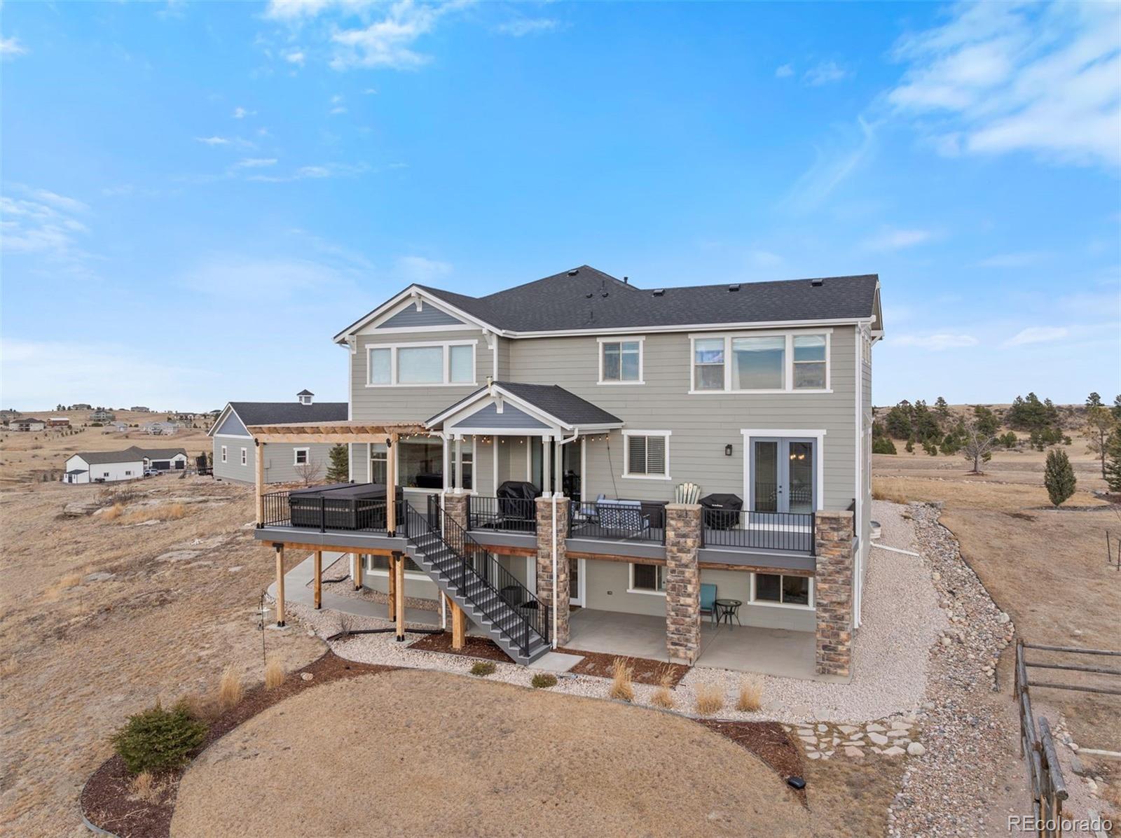 32335 Legacy Ridge Street Elizabeth, CO 80107 - Photo 43 of 50 a view of a house with wooden deck and furniture