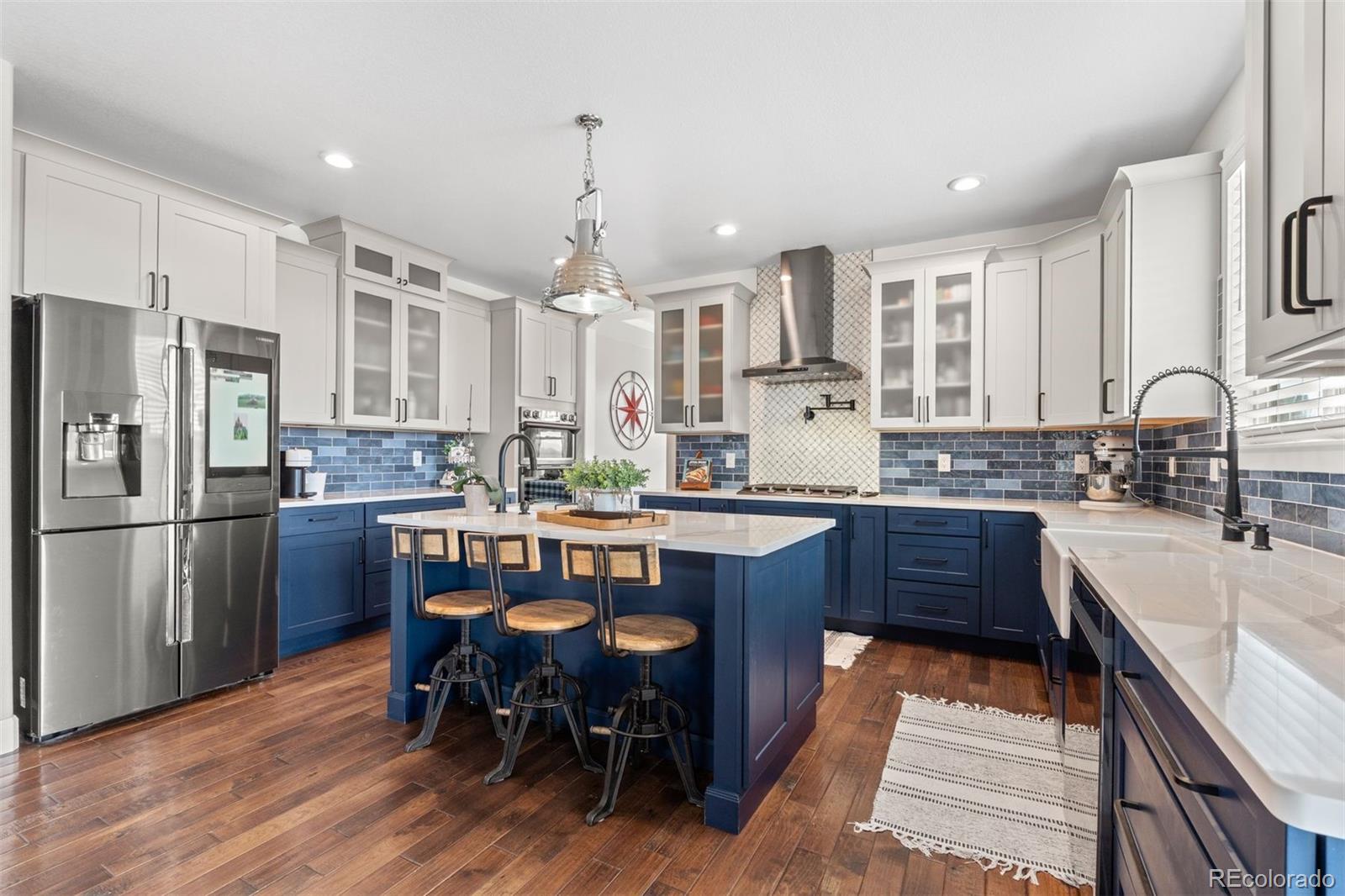 32335 Legacy Ridge Street Elizabeth, CO 80107 - Photo 5 of 50 a kitchen with stainless steel appliances granite countertop a sink dishwasher a stove a refrigerator with a dining table and chairs