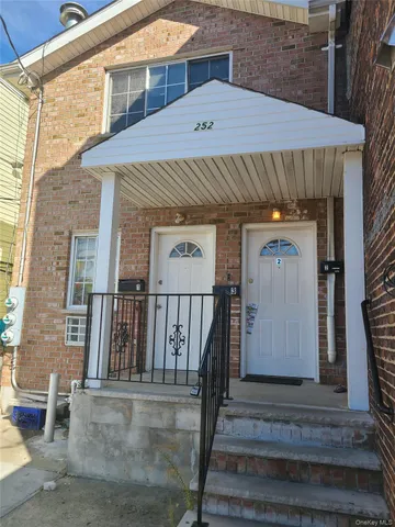 a front view of a house with wooden stairs