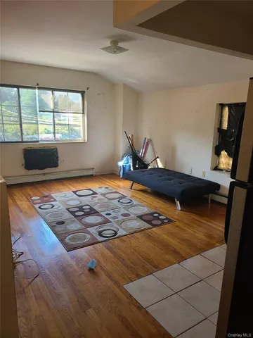 a bedroom with table and window