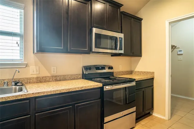 a kitchen with a sink stove and microwave