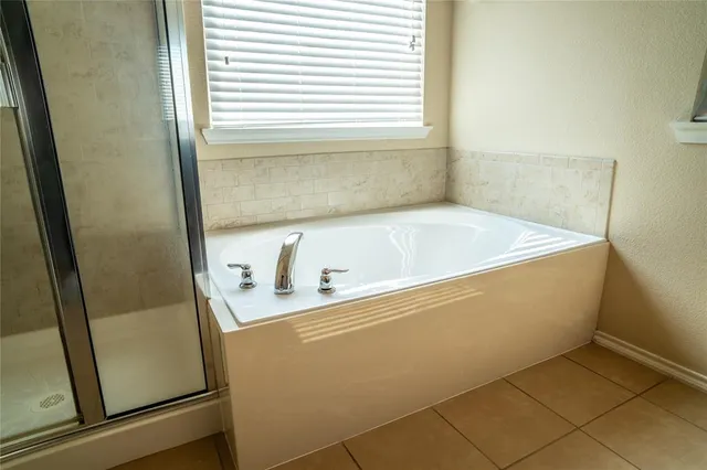 a bathroom with a bathtub and a window