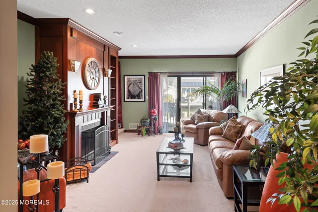 a living room with fireplace furniture and a large window
