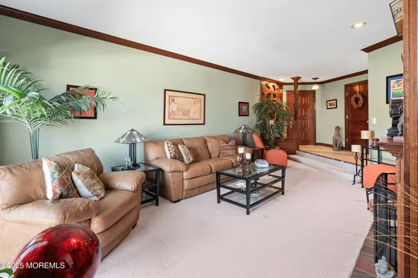 a living room with furniture and flowers