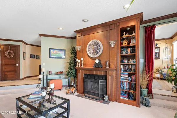 a living room with furniture a clock and a fireplace