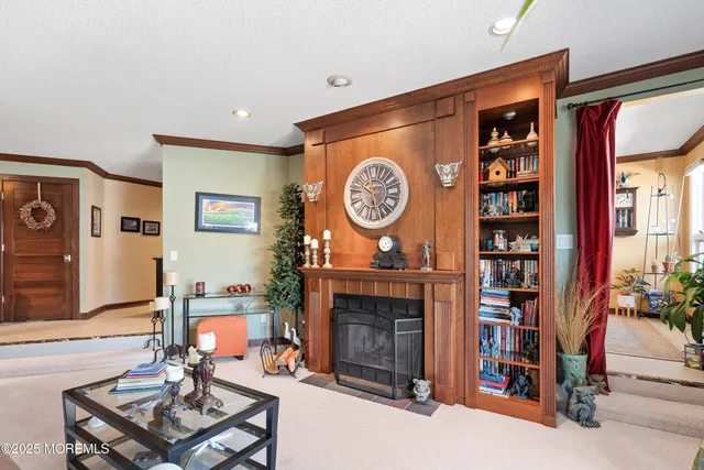a living room with furniture a clock and a fireplace