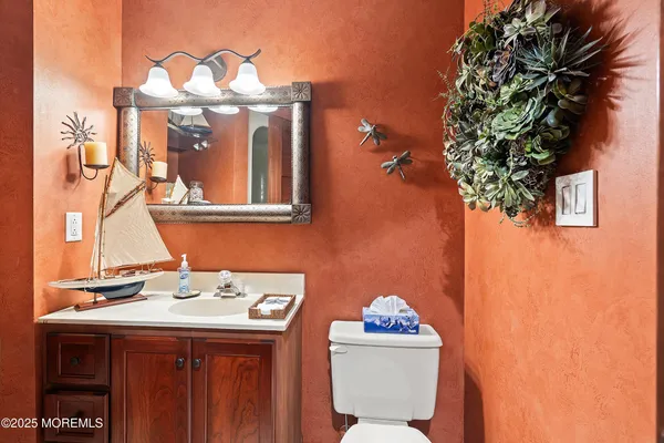 a bathroom with a sink a mirror and a toilet