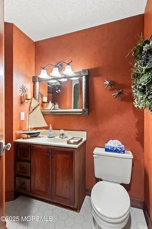 a bathroom with a toilet a sink and mirror