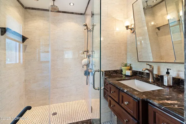 a bathroom with a sink double vanity and shower