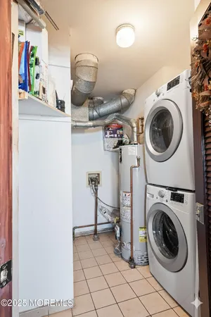 a view of a storage and utility room with washer and dryer