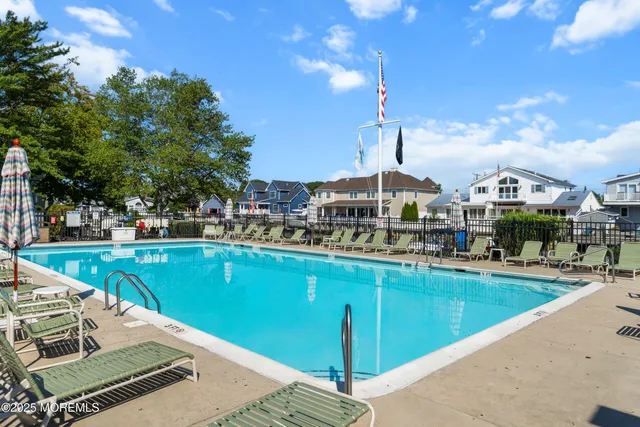 a view of a swimming pool with outdoor seating