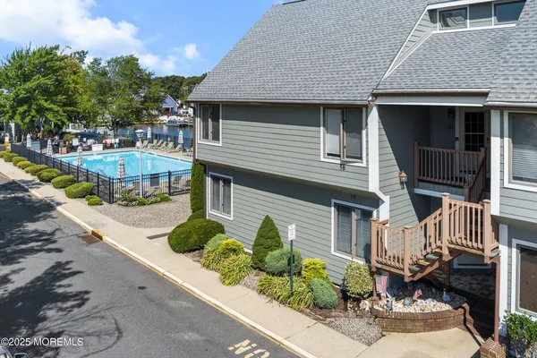 a front view of a house with a yard and outdoor seating