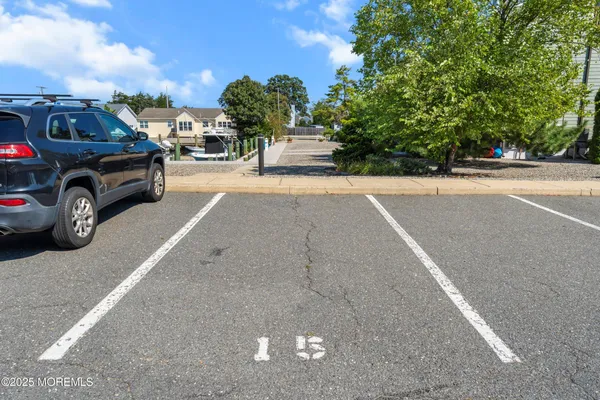 a view of a cars park on the side of a road