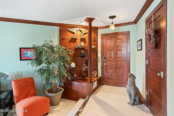 a living room with furniture potted plant and a large mirror