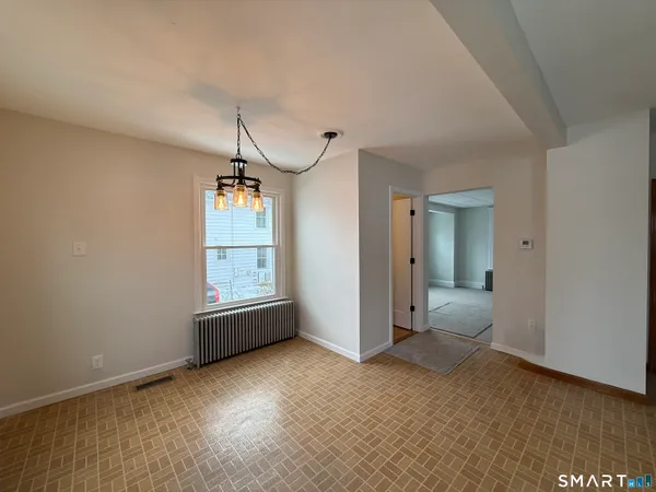 a view of a livingroom with a ceiling fan and window