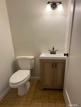 a white toilet sitting next to a sink