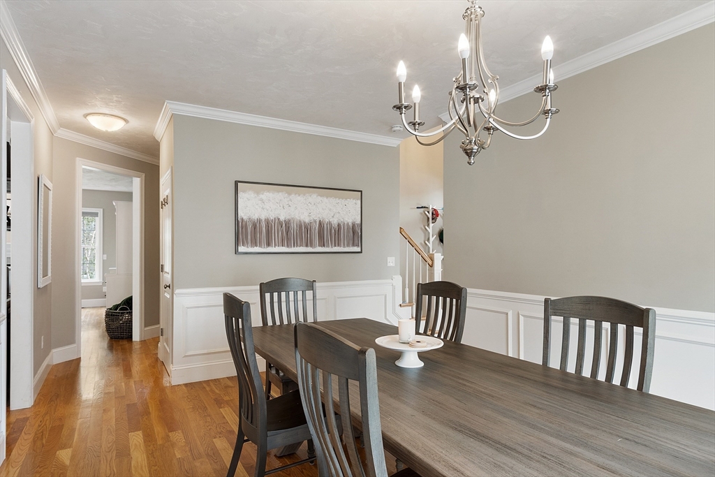 46 Jordan Road Holden, MA 01520 - Photo 11 of 42 a view of a dining room with furniture a chandelier and wooden floor