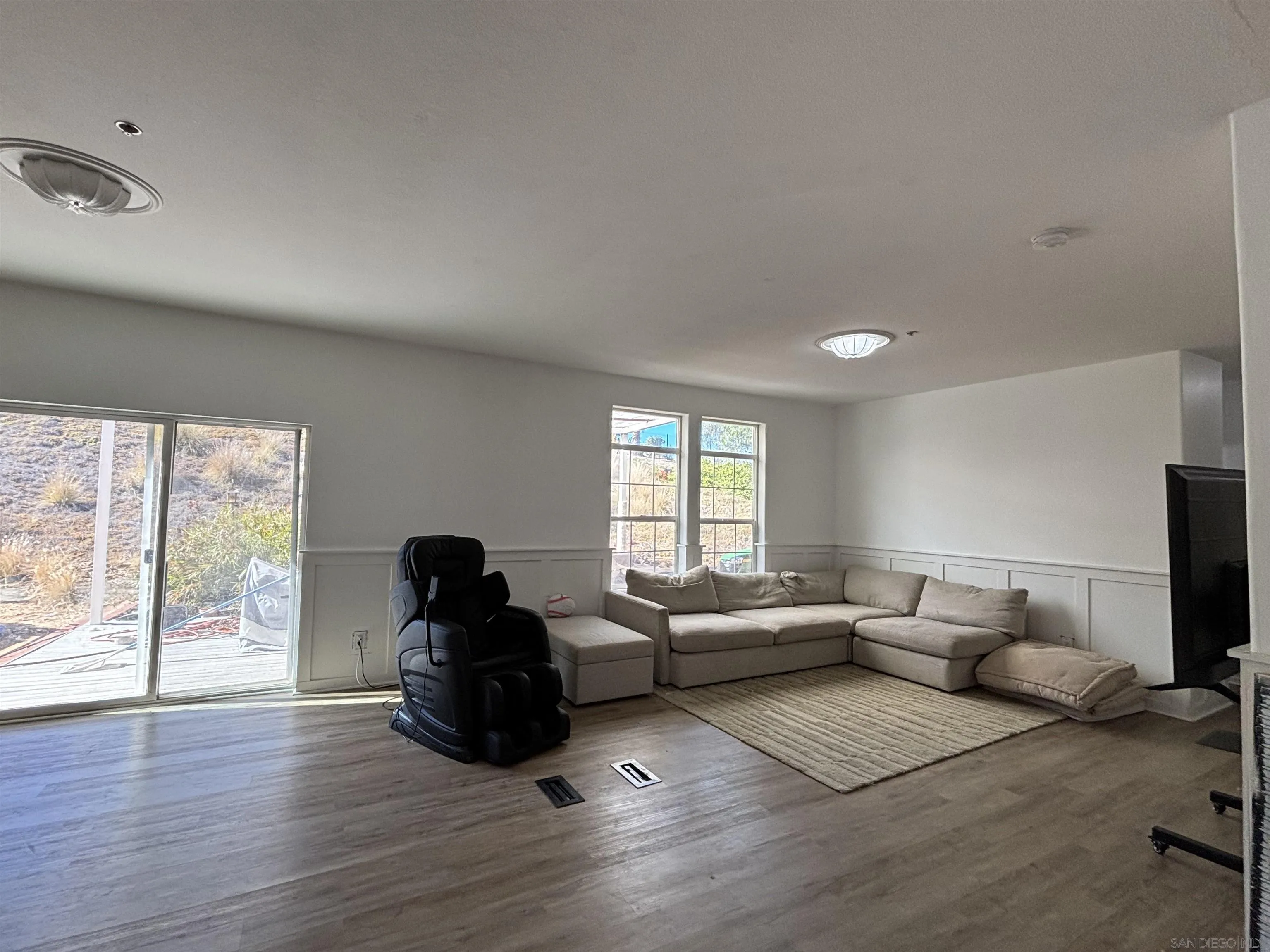6960 West Lilac Road Bonsall, CA 92003 - Photo 13 of 37 a living room with furniture window and wooden floor
