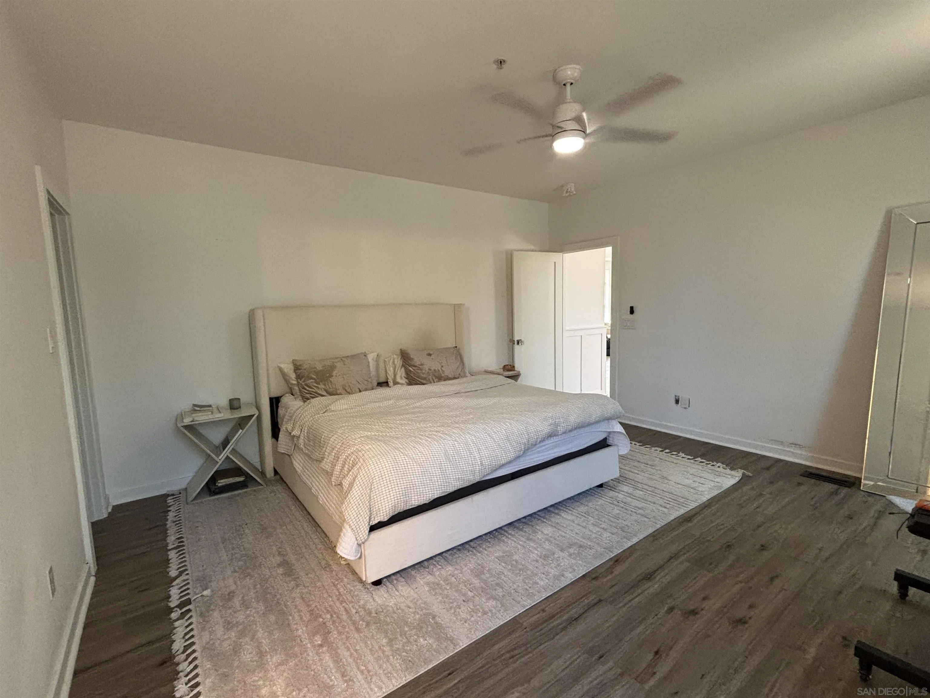 6960 West Lilac Road Bonsall, CA 92003 - Photo 17 of 37 a bedroom with a bed and a ceiling fan