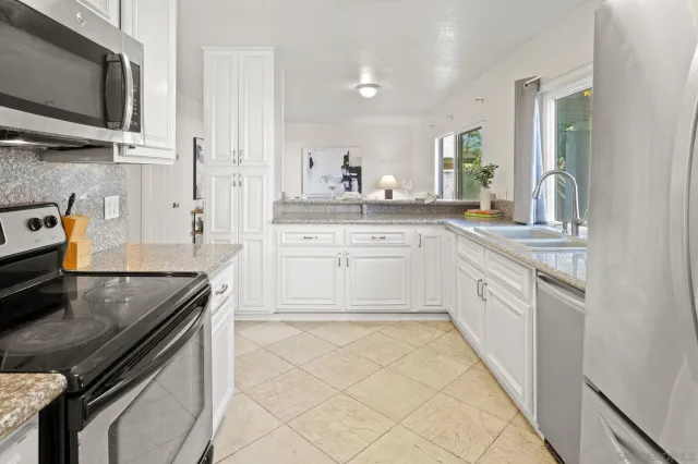 a kitchen with a sink stove and microwave