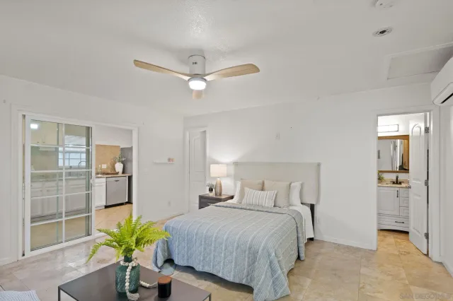 a bedroom with a bed and ceiling fan