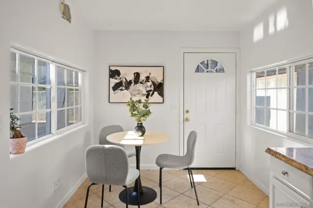 a view of a dining room with furniture a rug and a window