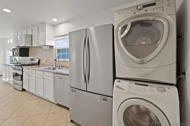 a view of a patio with table and chairs potted plants with floor to ceiling window