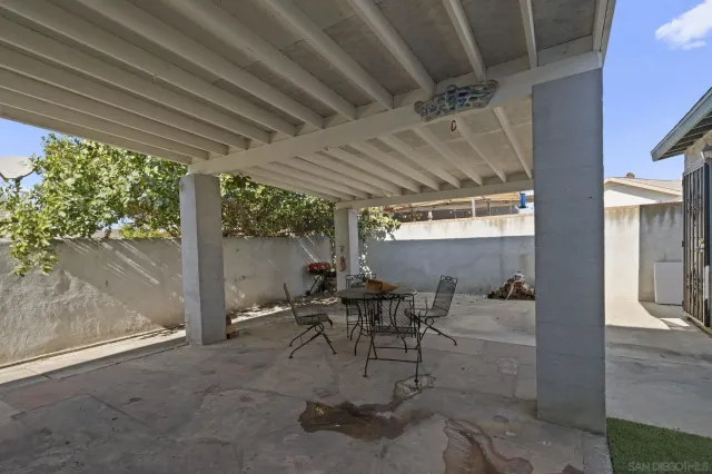 a view of a patio with table and chairs and potted plants
