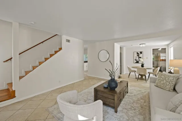 a living room with furniture and a potted plant